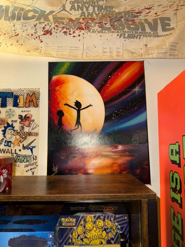 Space-themed wall mural with silhouetted characters