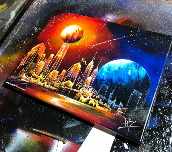 Spray-painted city skyline beneath colorful planets